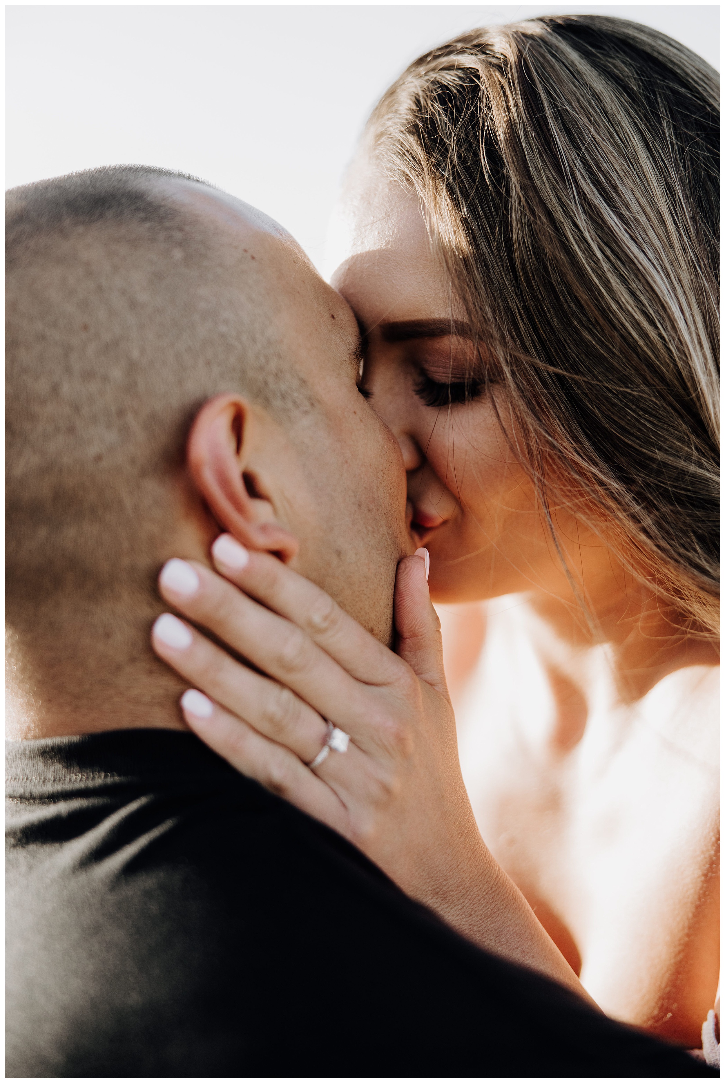 couple kissing at sunset