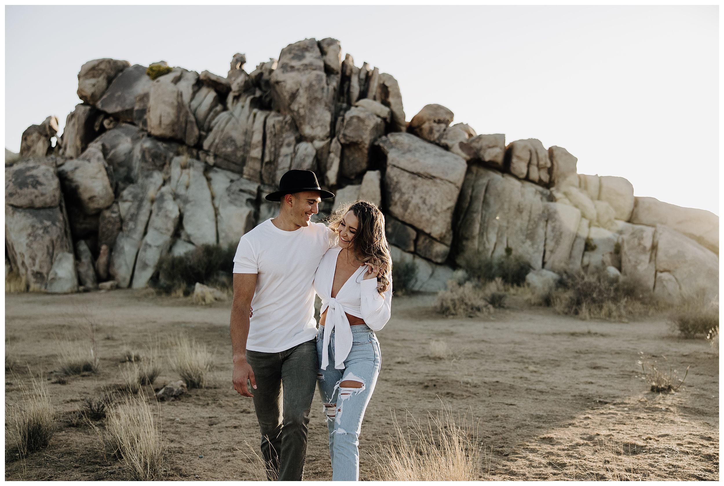 couple walking at joshua tree rocks