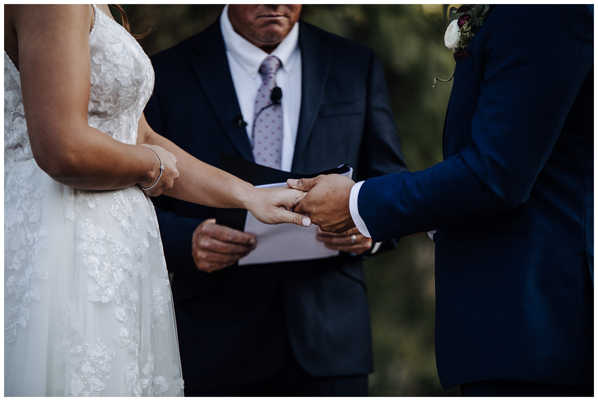 bride and groom holding hands during ceremony
