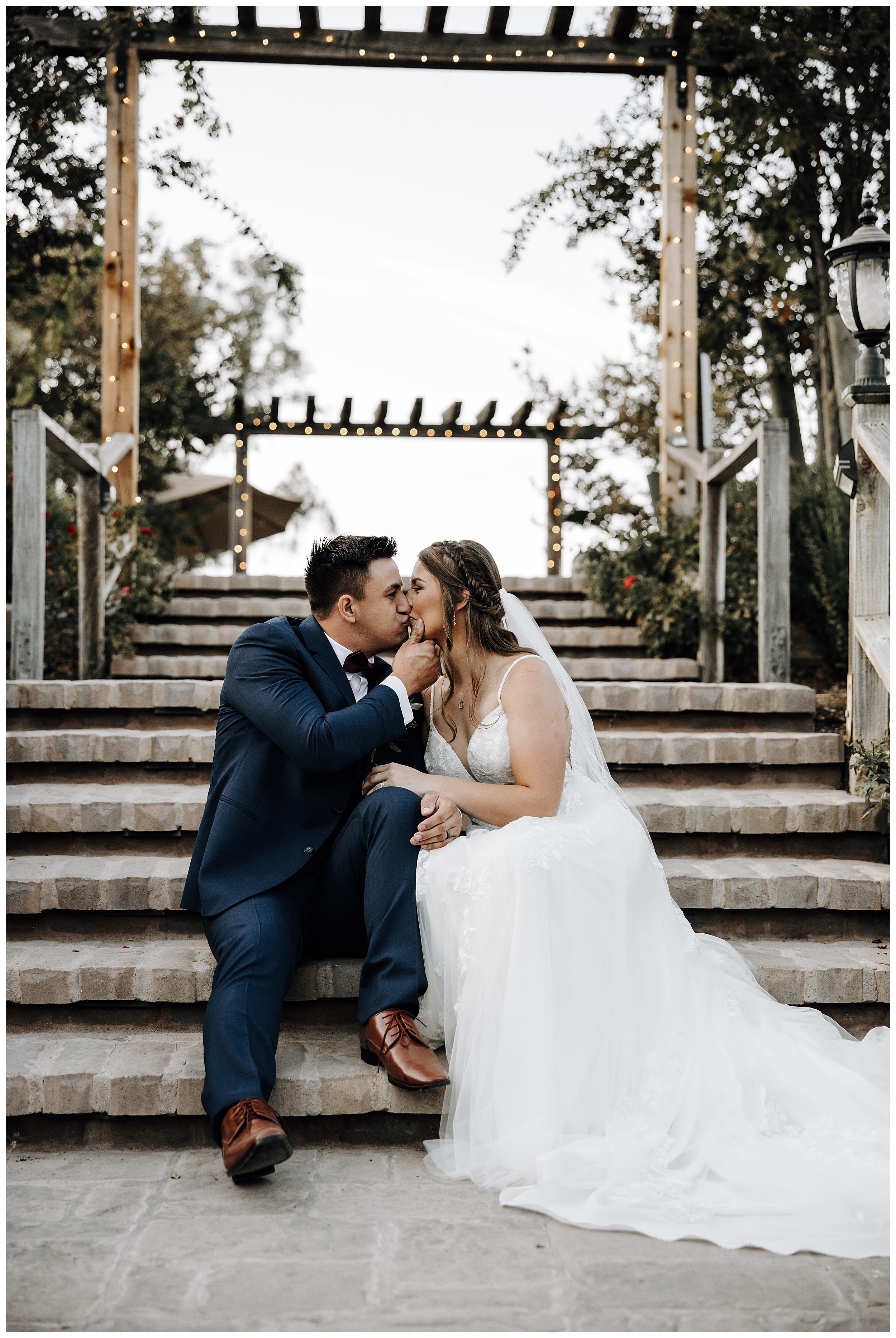 bride and groom kissing on stairs