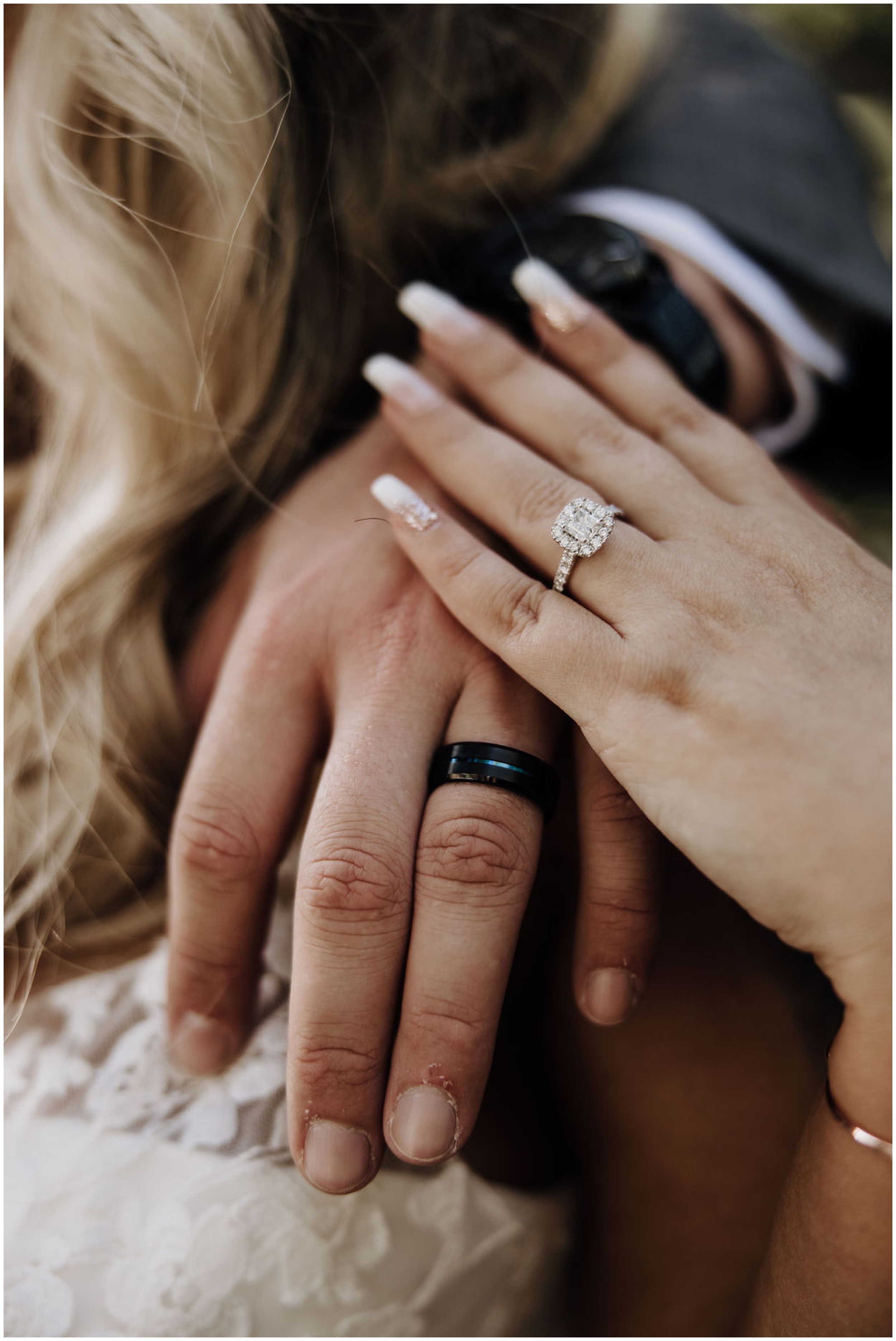 bride and groom showing off wedding rings