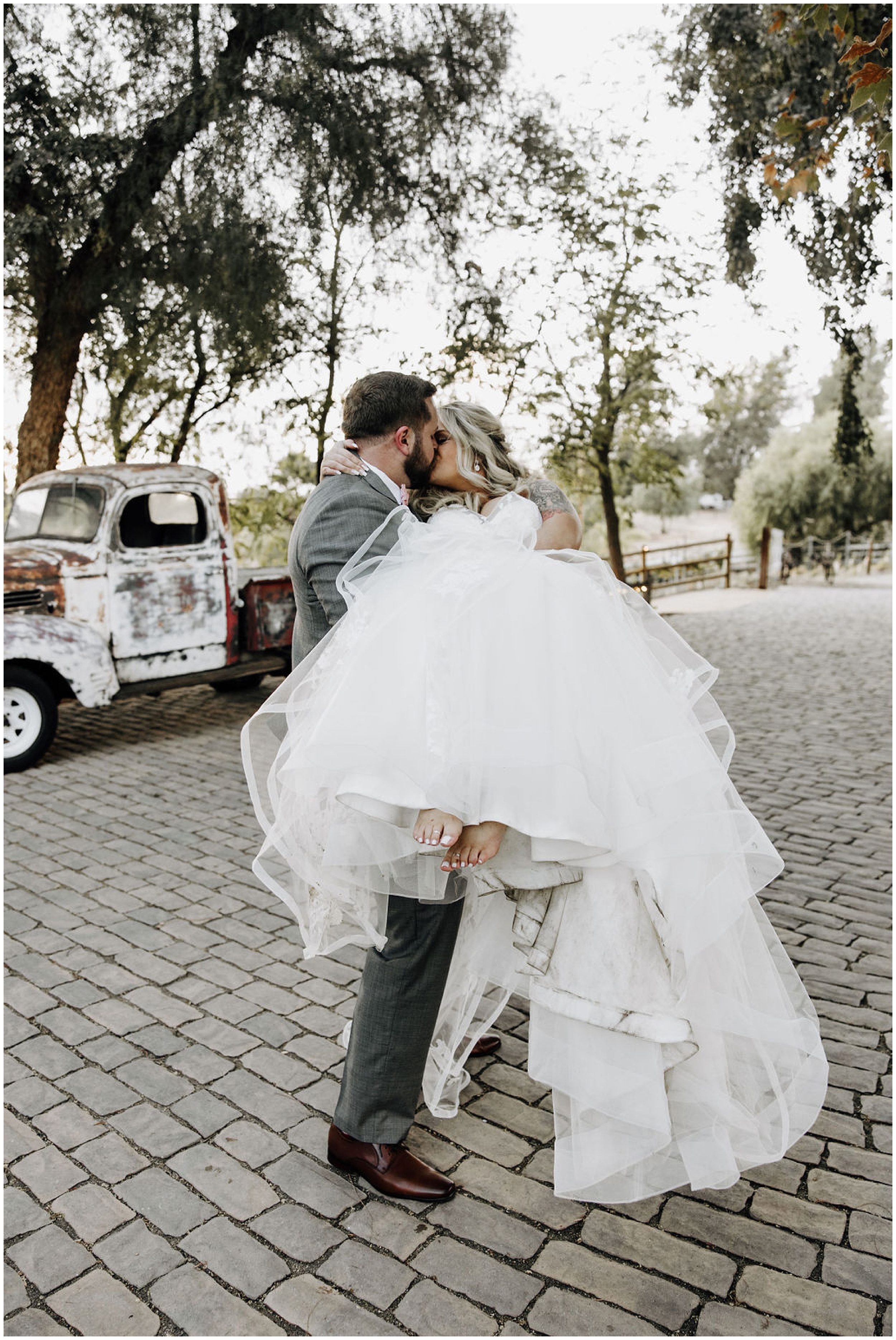 groom carrying and kissing bride