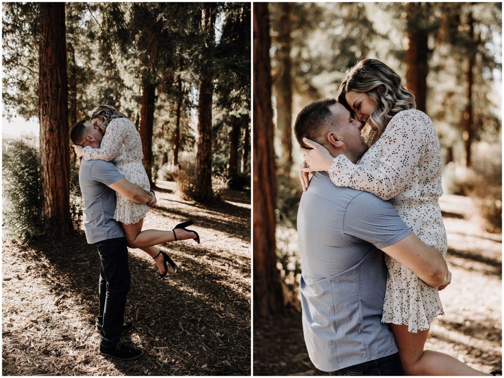 man picking up woman and kissing her