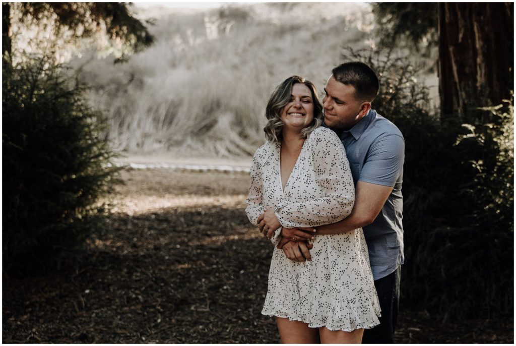 man hugging woman from behind