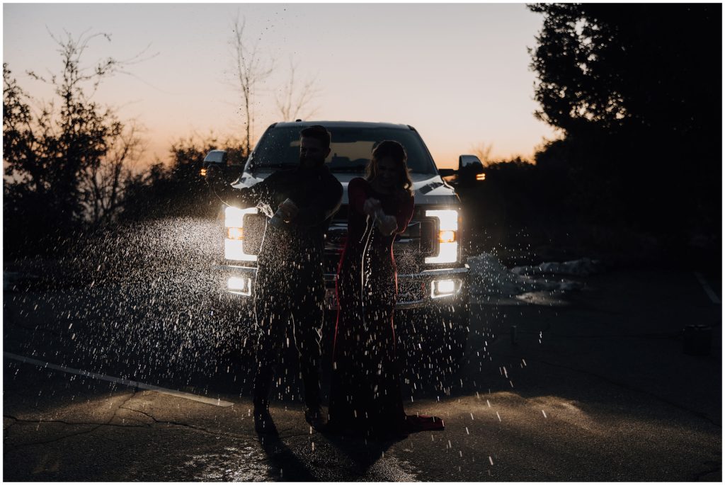 couple popping champagne