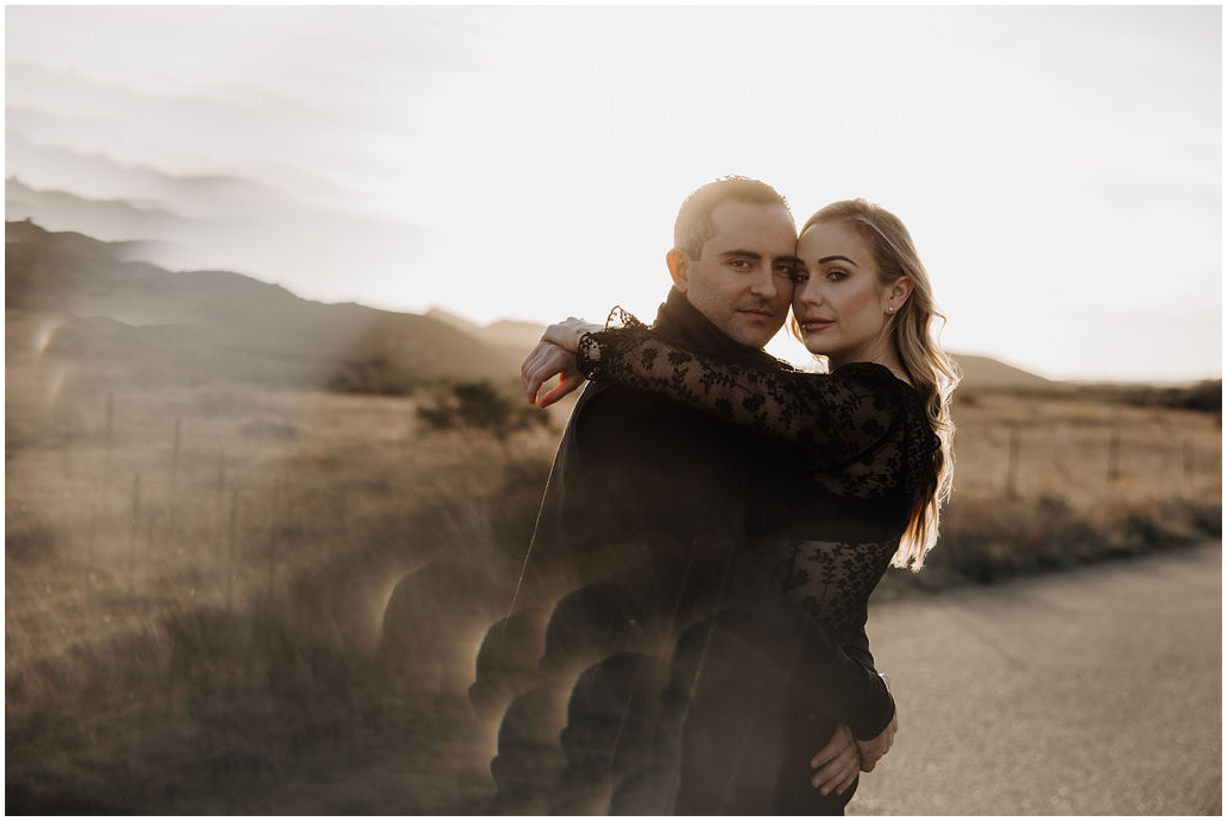 couple hugging and looking at camera