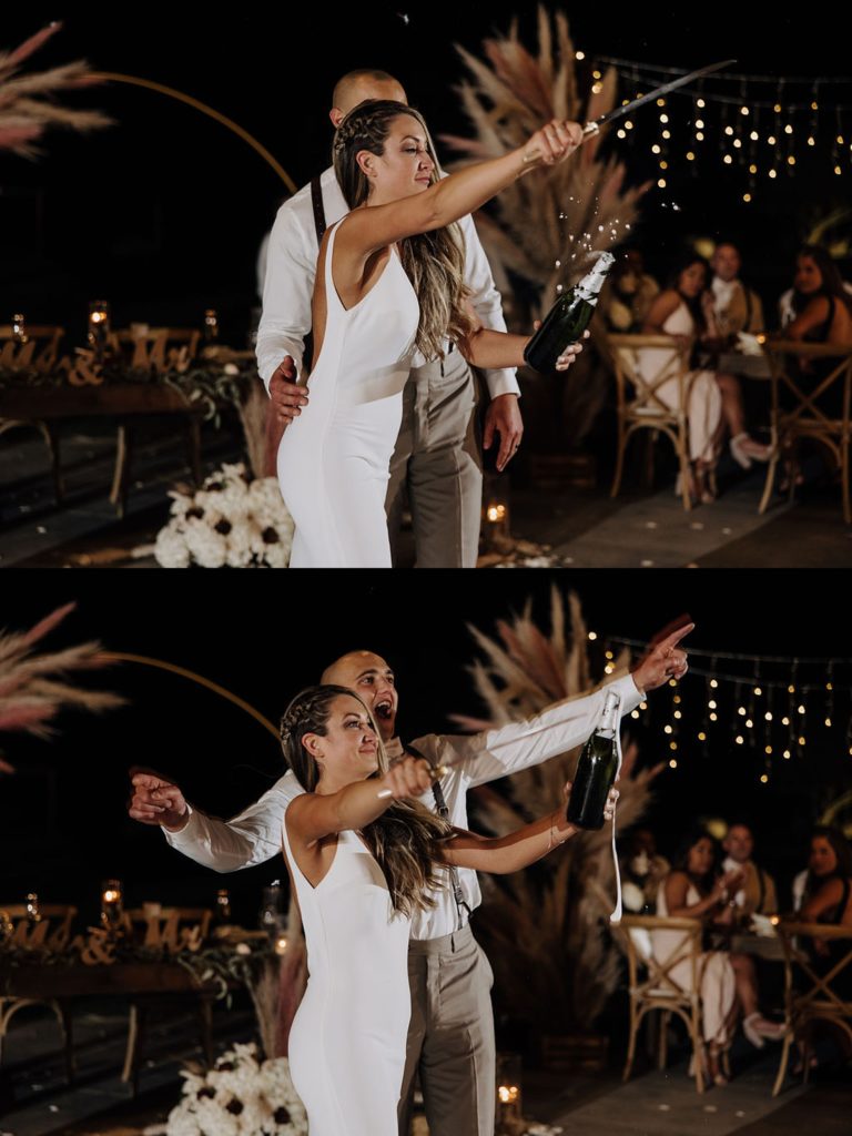 bride opening bottle of champagne with sword